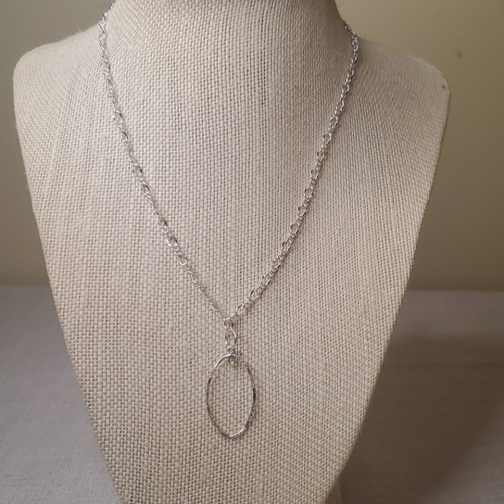 Silver plated necklace with oval charm.